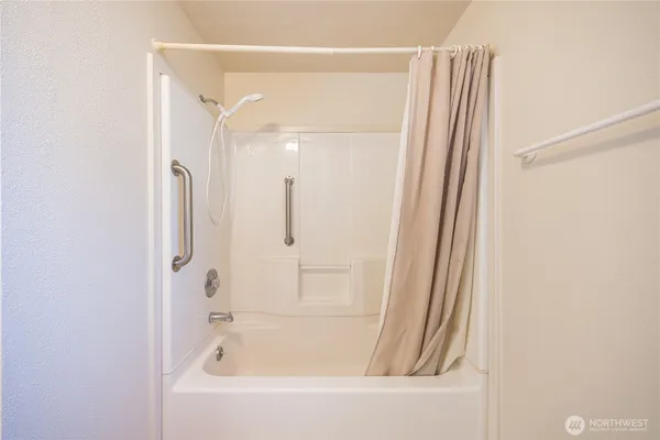 a bathroom with a bathtub and a shower