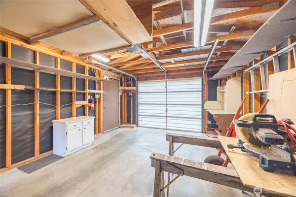 a view of an empty room with furniture and windows