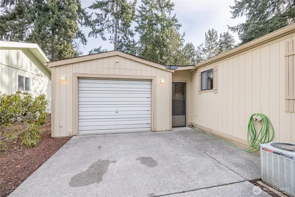 a view of a house with backyard and sitting area