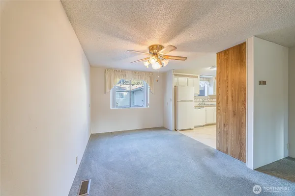 a view of a kitchen with a sink and a refrigerator