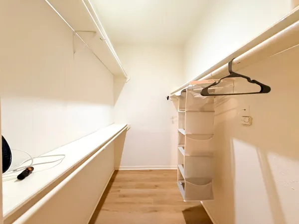 a living room with a bed furniture and a large window