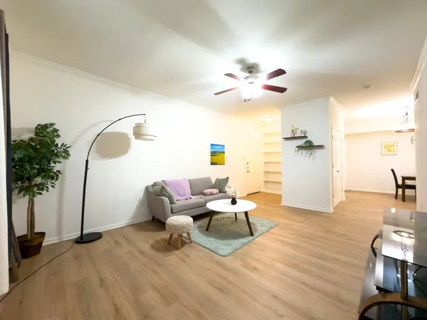 a living room with furniture and a chandelier