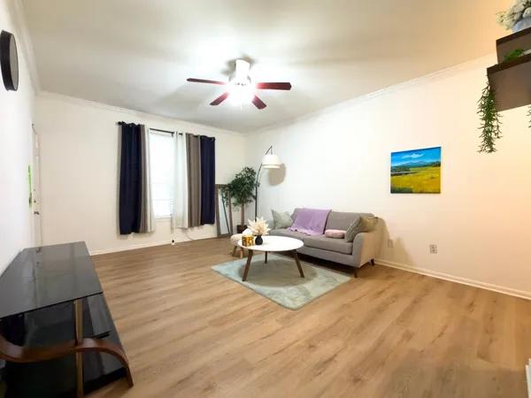 a view of a dining room with furniture and wooden floor
