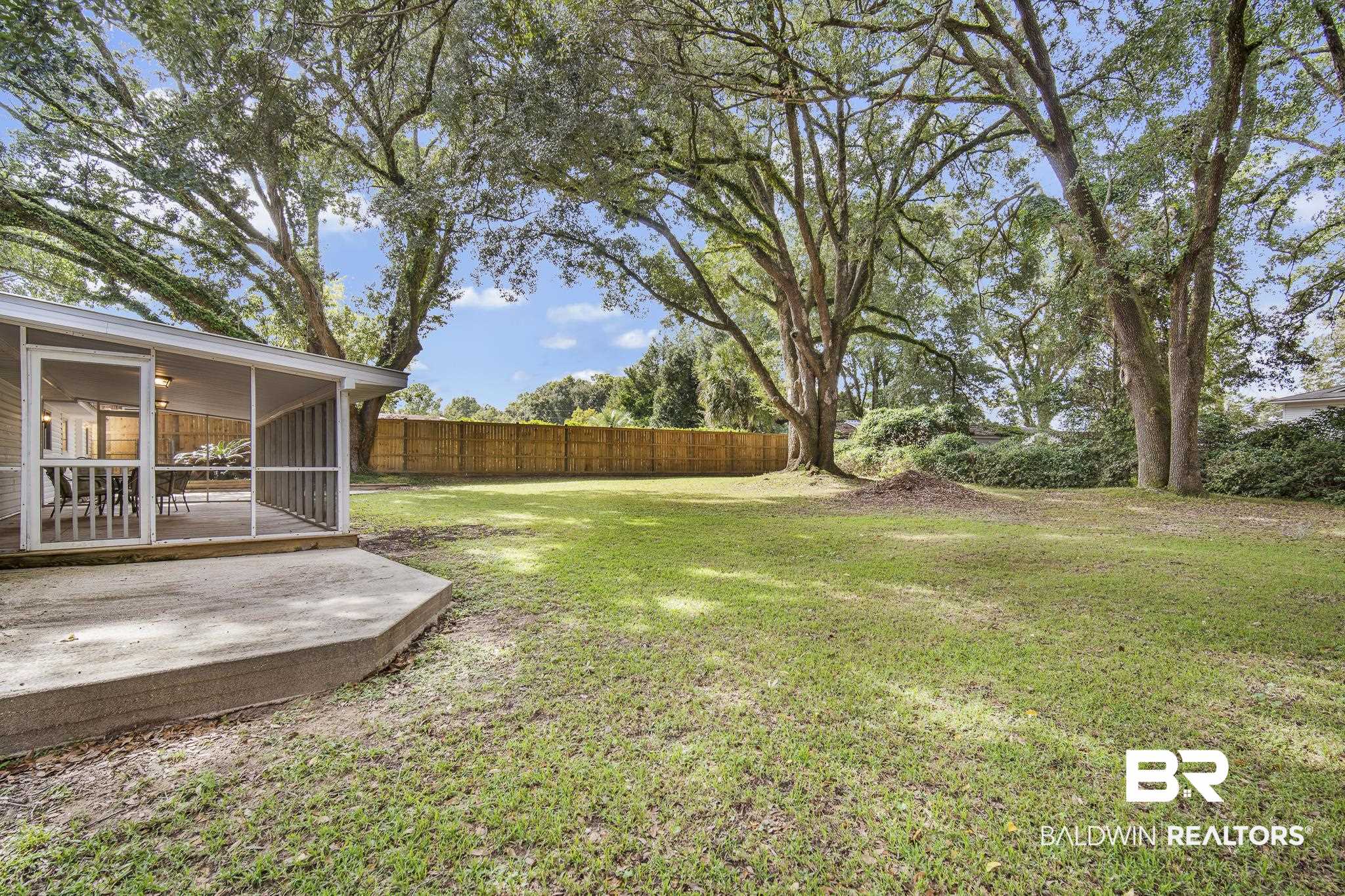 103 Ann Street Daphne, AL 36527 - Photo 19 of 23 Fenced backyard featuring a sunroom and a patio area