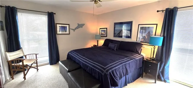 a bedroom with a bed and a mirror on dresser