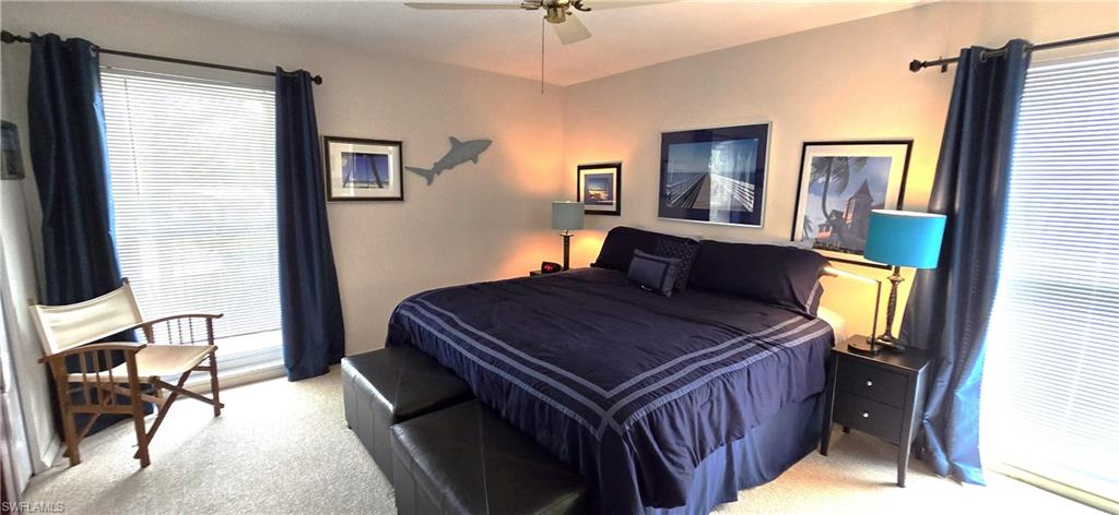 69 Georgetown Boulevard, Unit 69 Naples, FL 34112 - Photo 11 of 21 a bedroom with a bed and a mirror on dresser