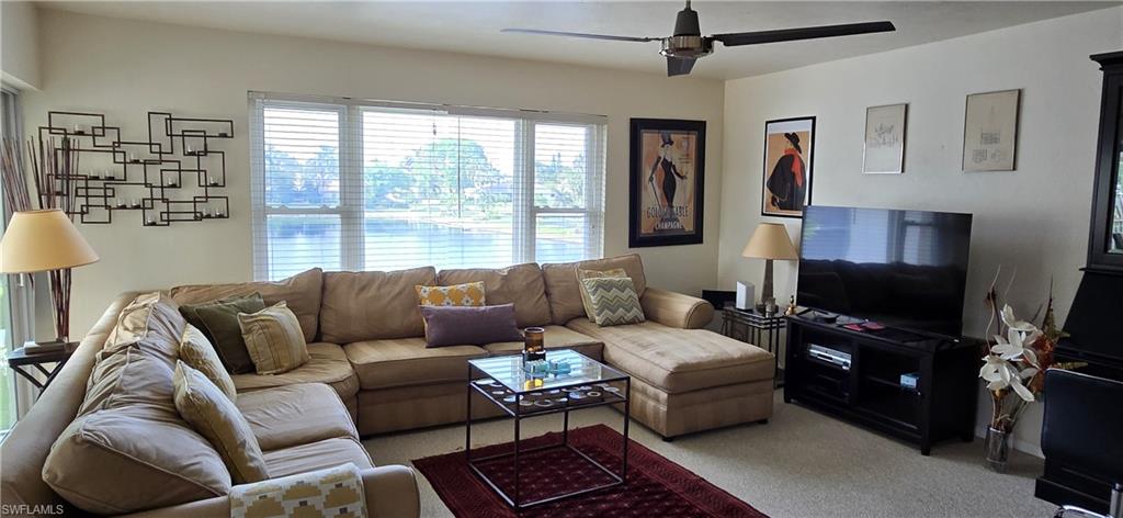69 Georgetown Boulevard, Unit 69 Naples, FL 34112 - Photo 4 of 21 a living room with furniture and a flat screen tv