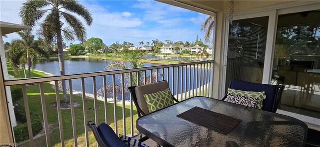 a view of a balcony with two chairs and a table
