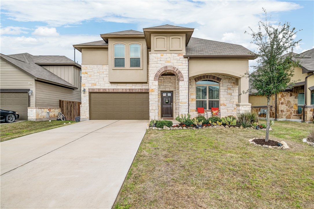 a front view of a house with garden