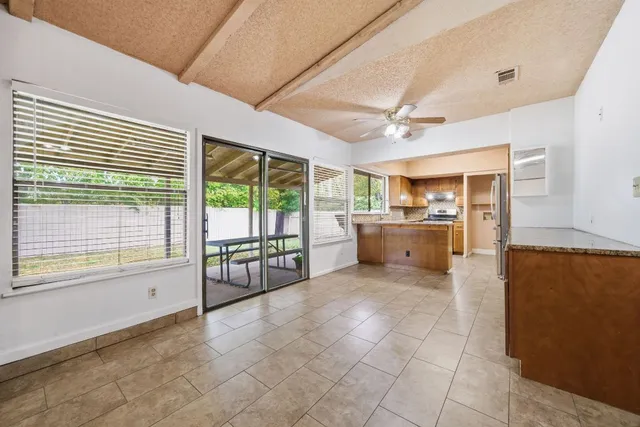a large kitchen with a large window a counter space and stainless steel appliances