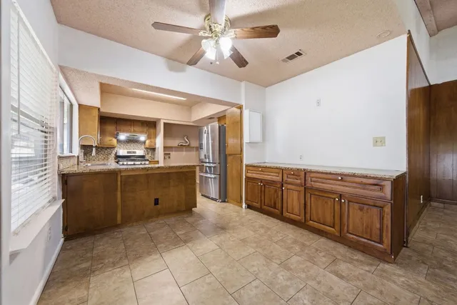 a kitchen with cabinets and window