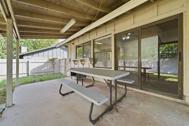 a building outdoor space with patio furniture and garden