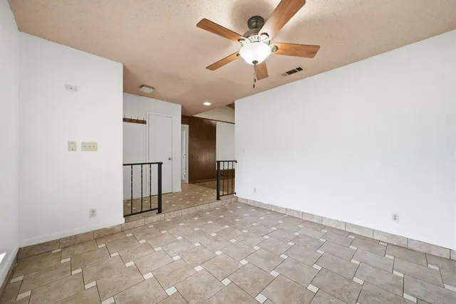 a view of a livingroom with a ceiling fan and window