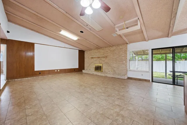 a view of an empty room with a fireplace