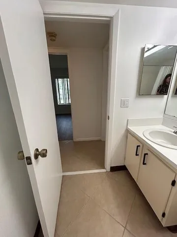 a view of a hallway in a house with wooden floor
