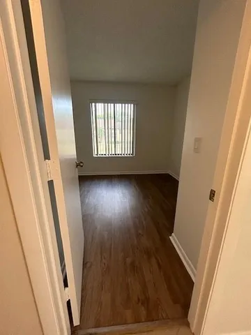 a view of an empty room and wooden floor