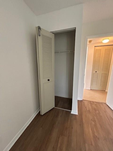 721 Sunny Pine Way, Unit G2 Greenacres, FL 33415 - Photo 20 of 34 an empty room with wooden floor and closet