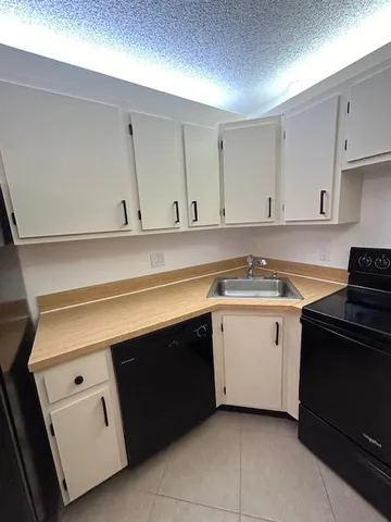 a kitchen with cabinets appliances and a sink