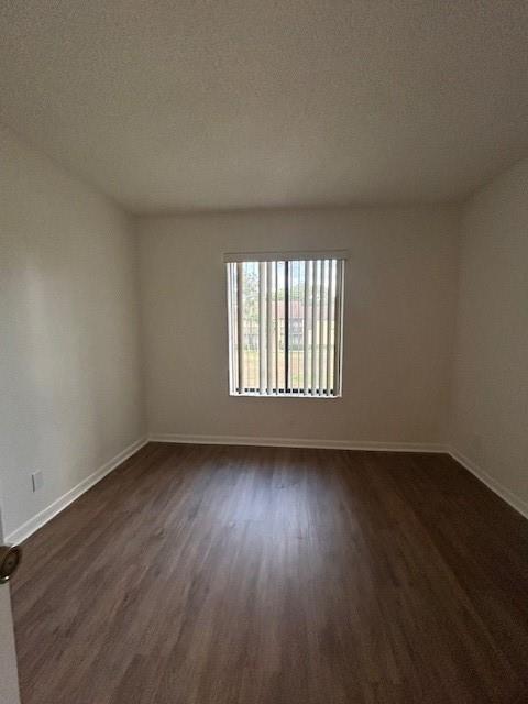 721 Sunny Pine Way, Unit G2 Greenacres, FL 33415 - Photo 21 of 34 an empty room with wooden floor and windows