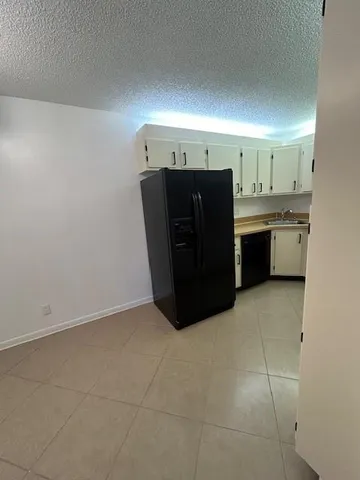 a kitchen with a refrigerator and cabinets