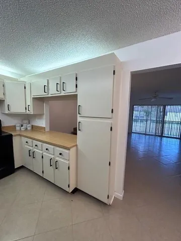 a kitchen with cabinets and wooden floors