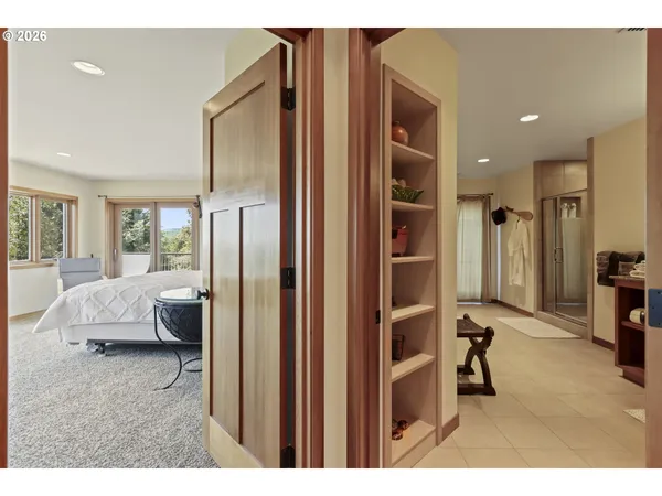 a bedroom with a large bed and a large window
