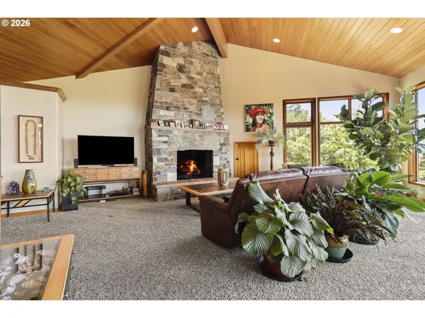 a living room with patio furniture and a fireplace