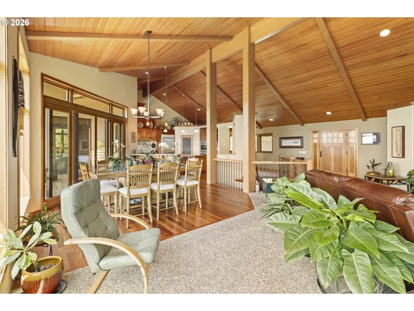 a view of a dining room with furniture large windows and wooden floor