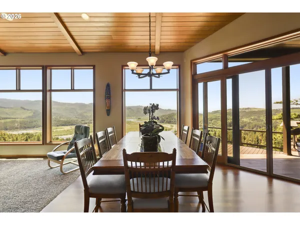 a dining room with furniture window and wooden floor