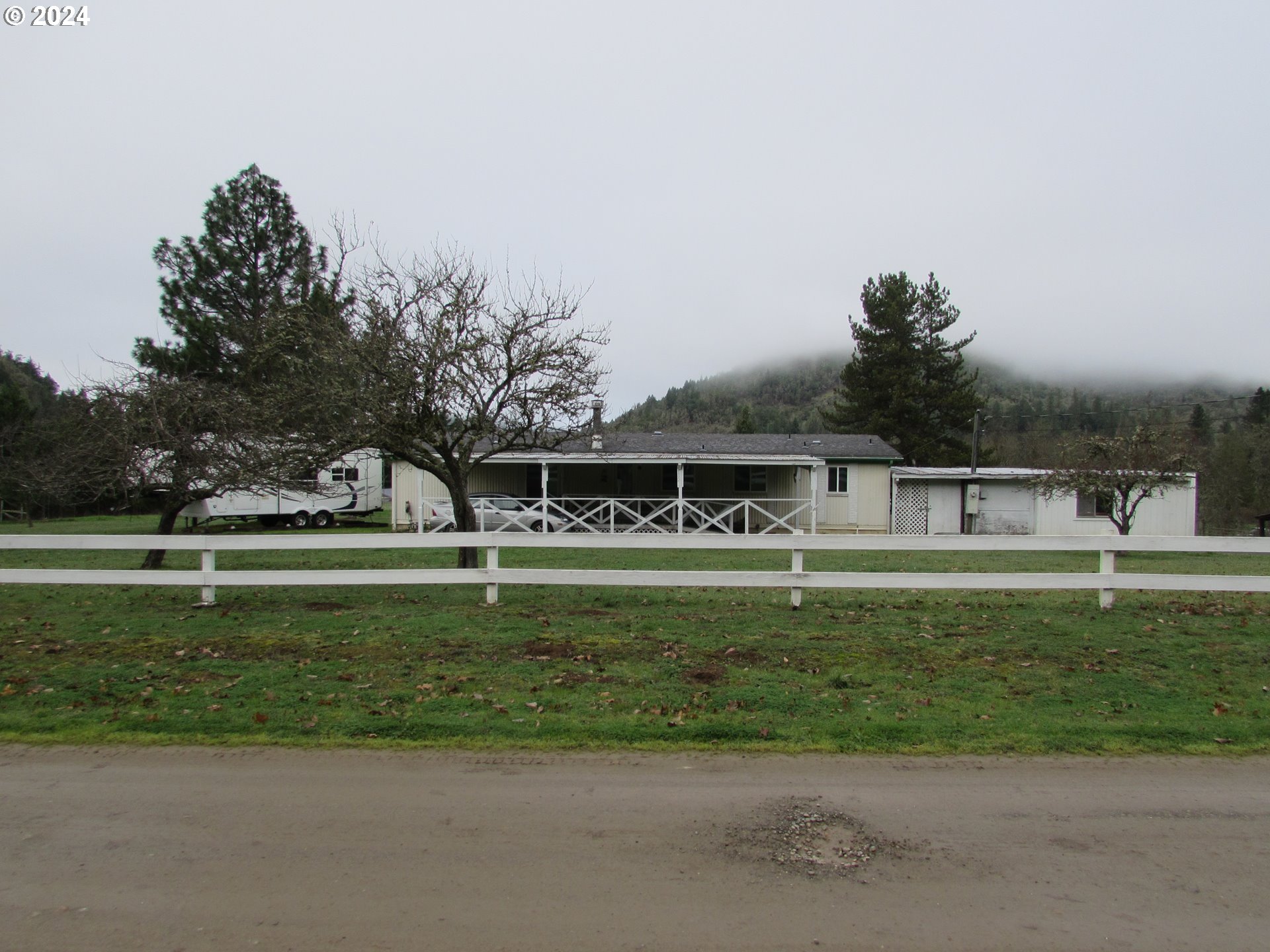 449 Evergreen Ridge Road Riddle, OR 97469 - Photo 1 of 21 a front view of a house with a yard