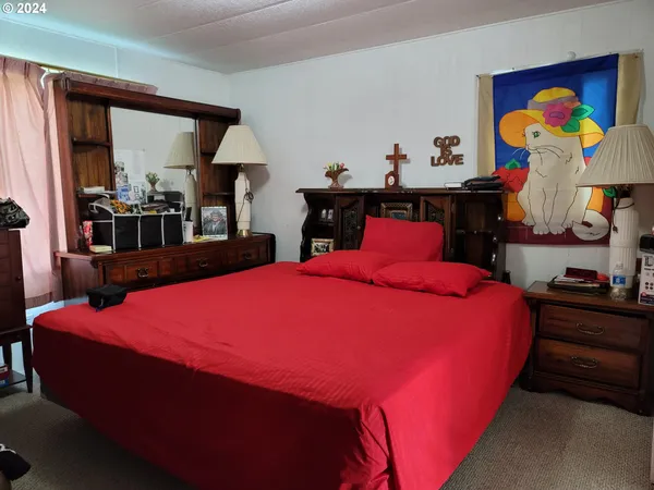 a blue bed sitting in a bedroom next to a window