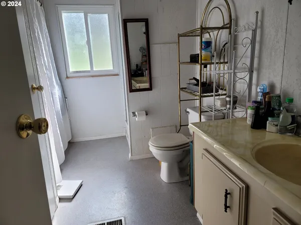 a bathroom with a sink vanity and mirror