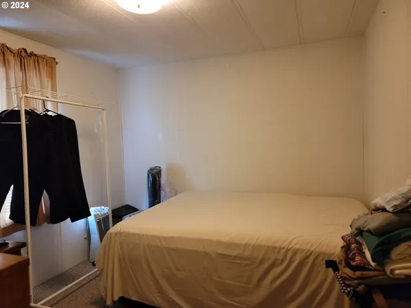 a bathroom with a toilet and a shower curtain