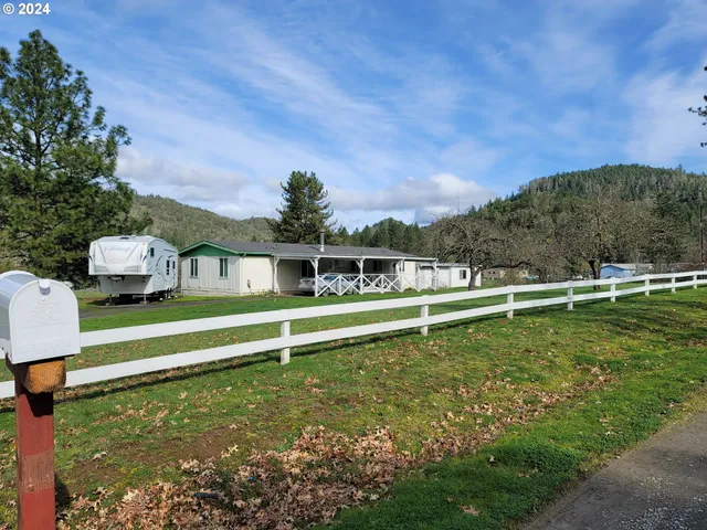 a kitchen with cabinets appliances and wooden floor