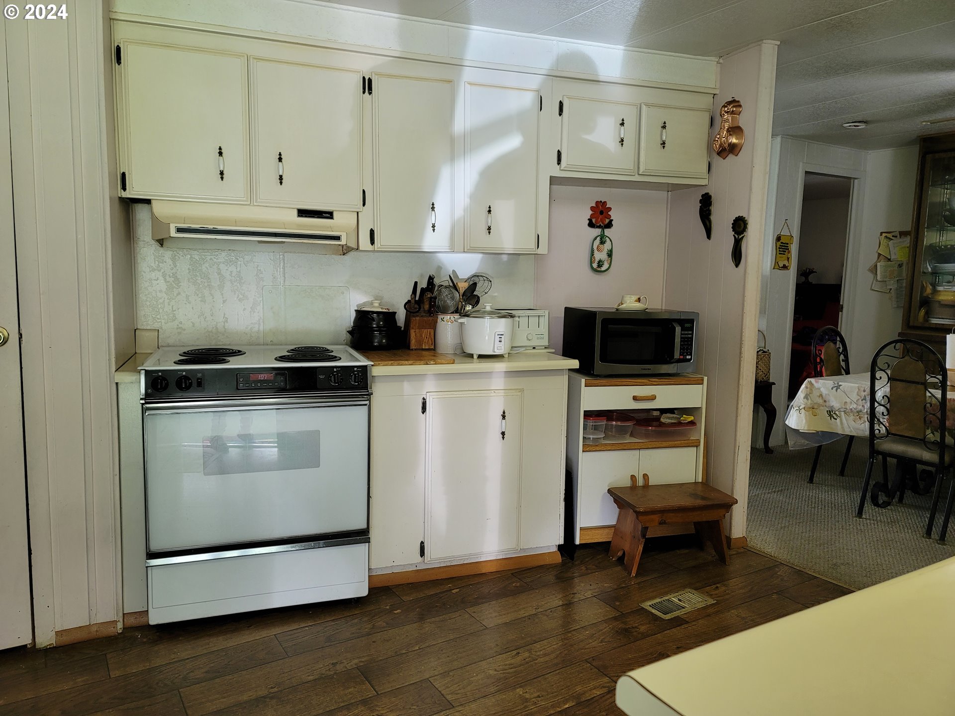 449 Evergreen Ridge Road Riddle, OR 97469 - Photo 3 of 21 a kitchen with cabinets appliances and wooden floor