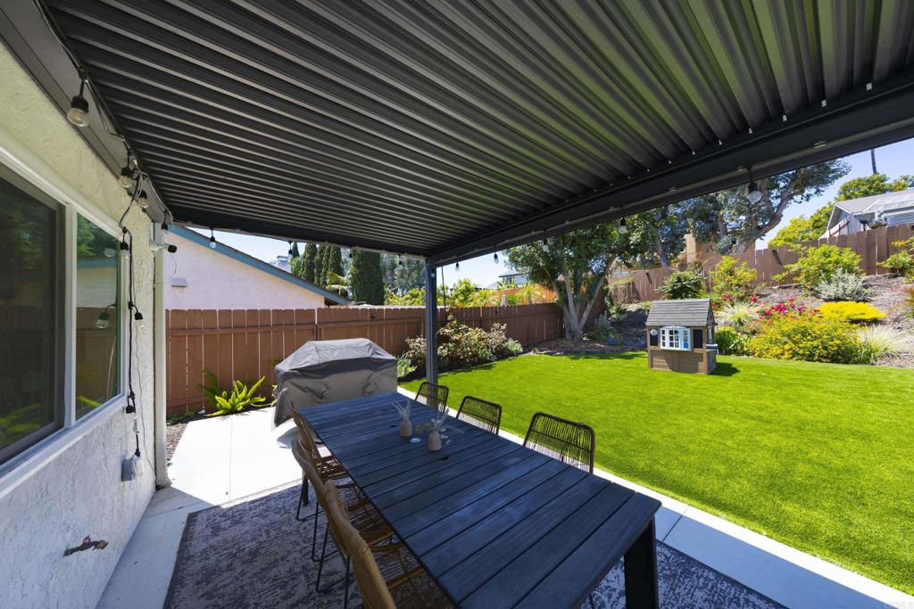 3577 Winslow Road Oceanside, CA 92056 - Photo 34 of 53 a view of a patio with table and chairs potted plants with wooden floor