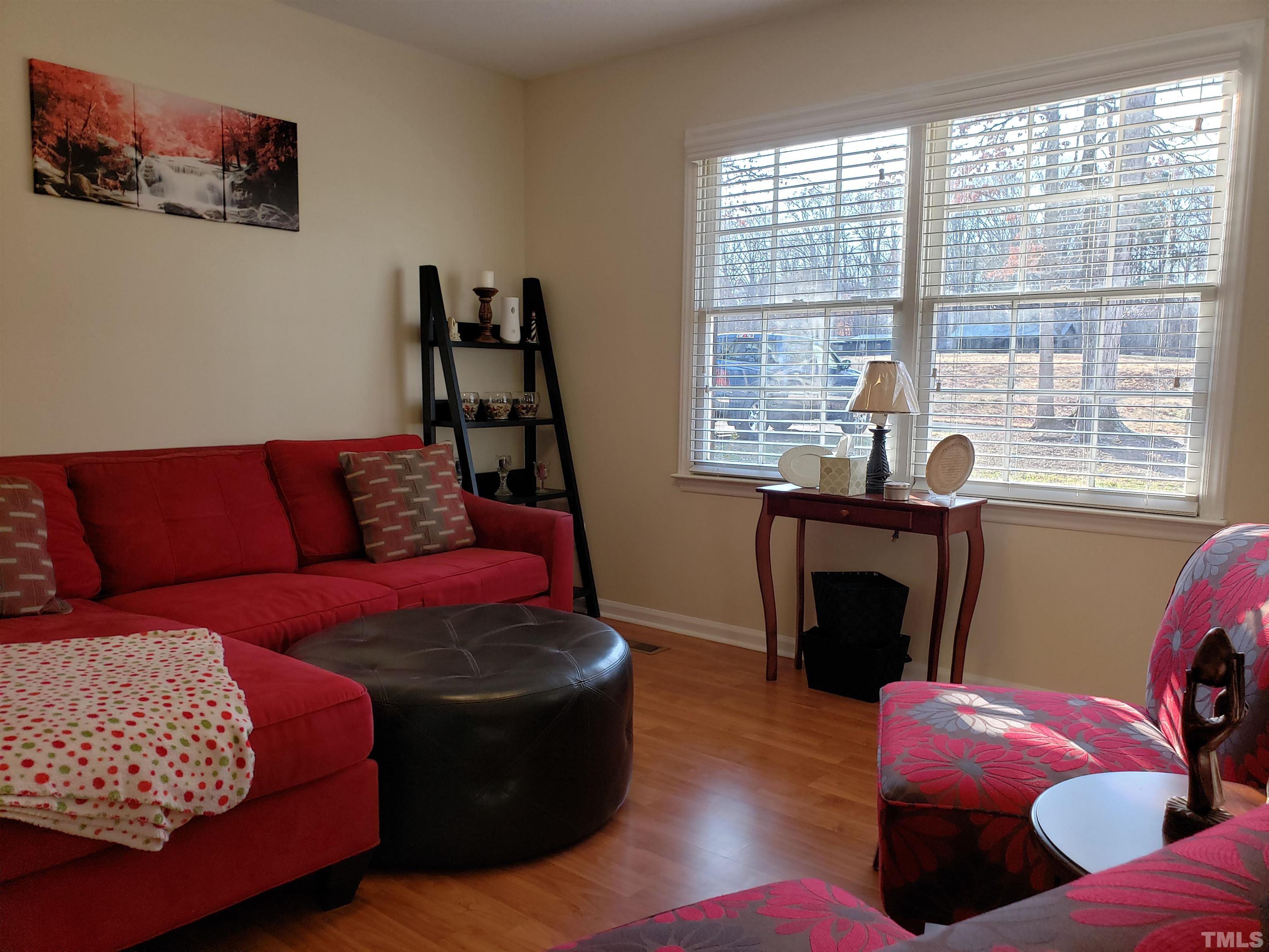 5610 Earl Road Durham, NC 27712 - Photo 11 of 38 a living room with furniture fireplace and window