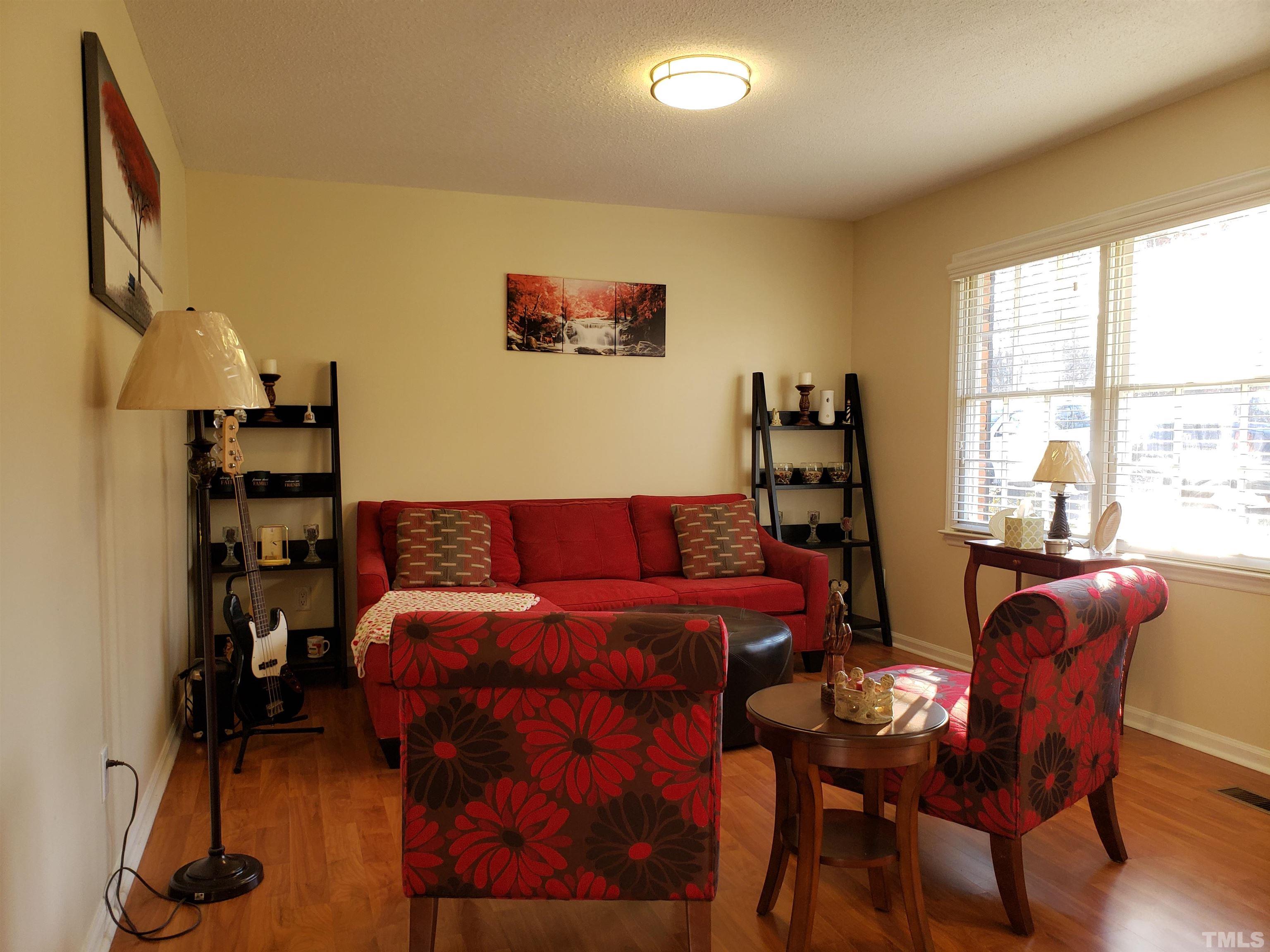5610 Earl Road Durham, NC 27712 - Photo 12 of 38 a living room with furniture a rug and a large window