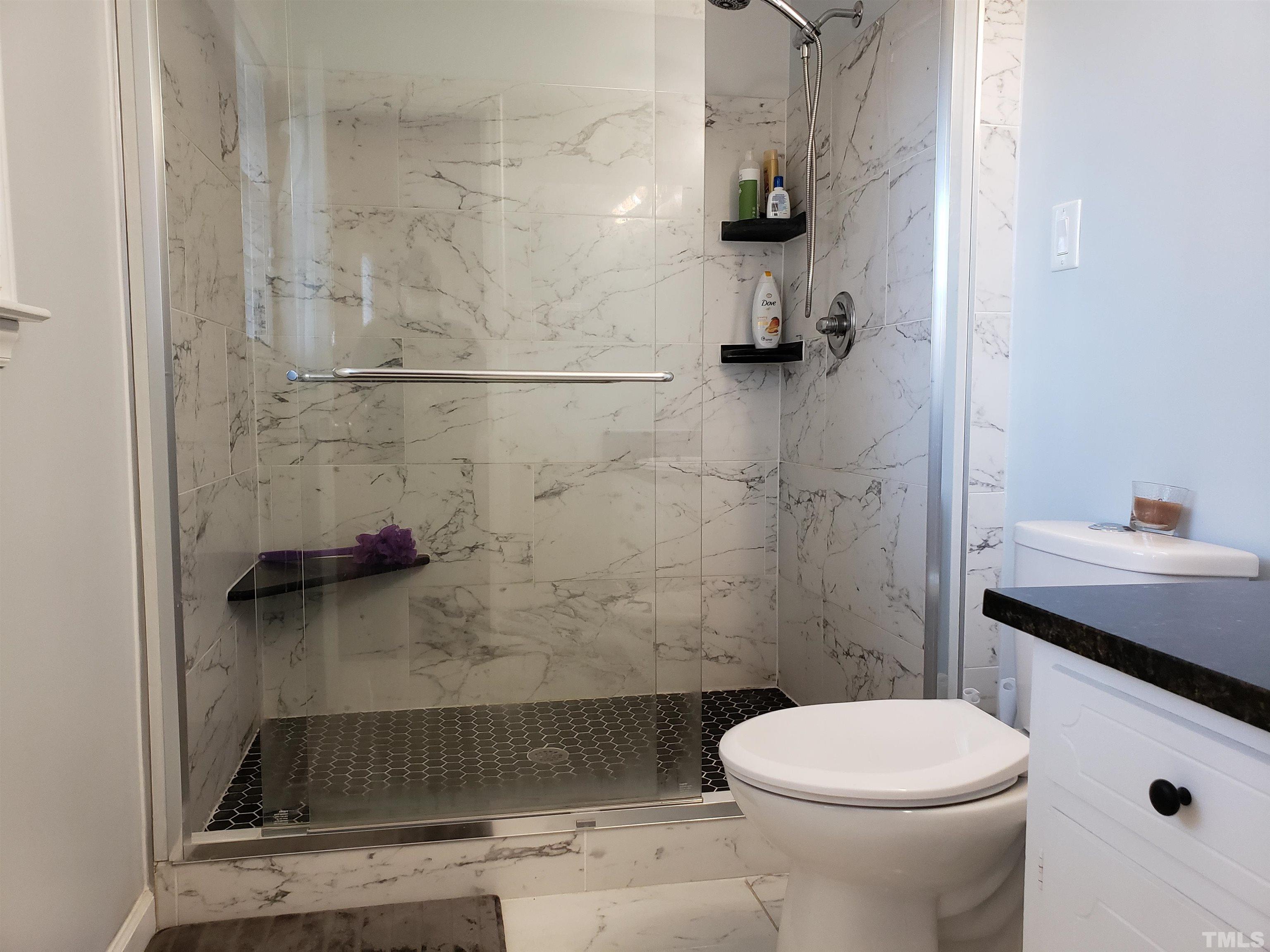 5610 Earl Road Durham, NC 27712 - Photo 17 of 38 a bathroom with a sink a toilet and shower