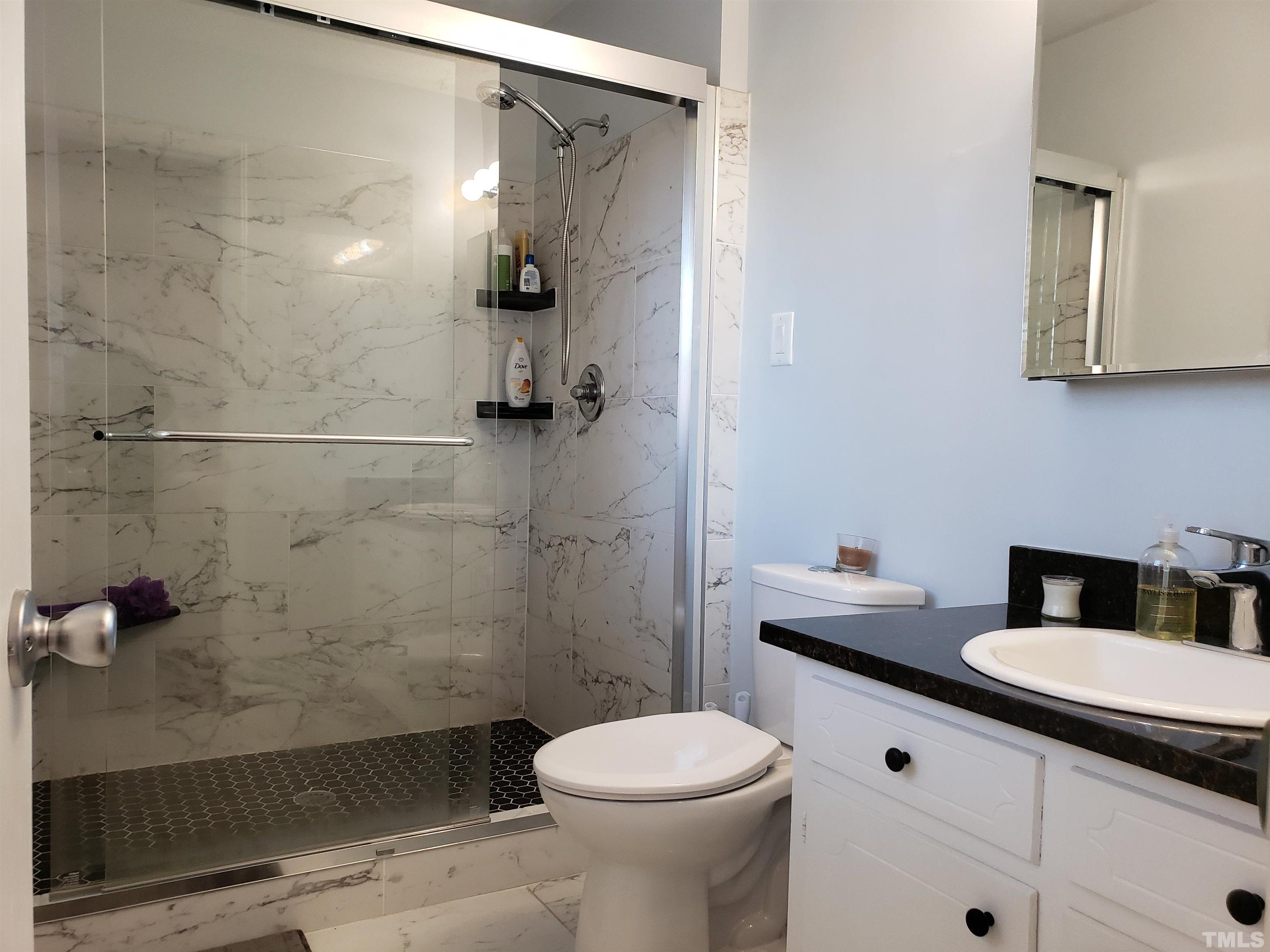 5610 Earl Road Durham, NC 27712 - Photo 18 of 38 a bathroom with a sink toilet and shower
