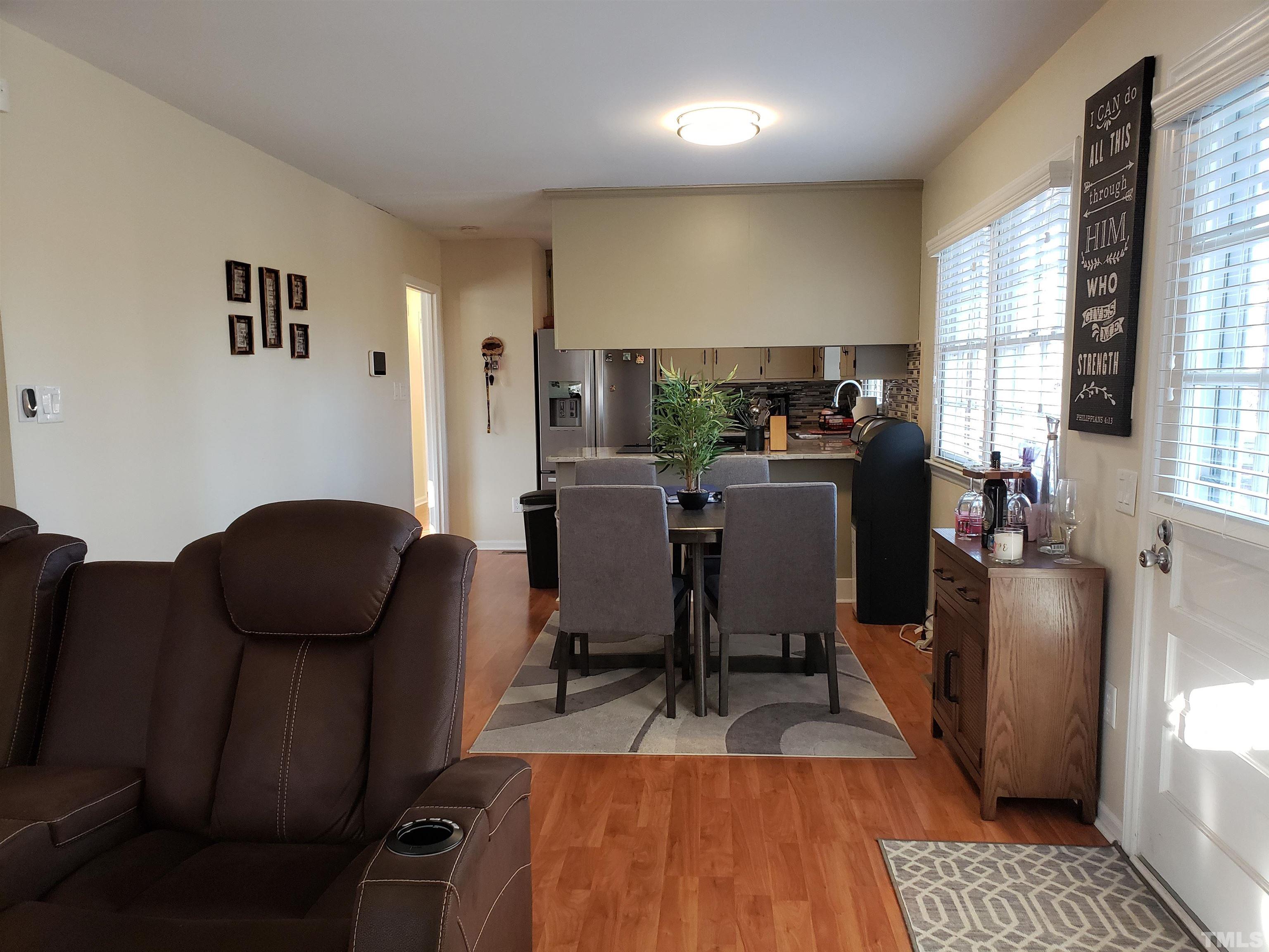 5610 Earl Road Durham, NC 27712 - Photo 24 of 38 a view of a dining room with furniture and wooden floor