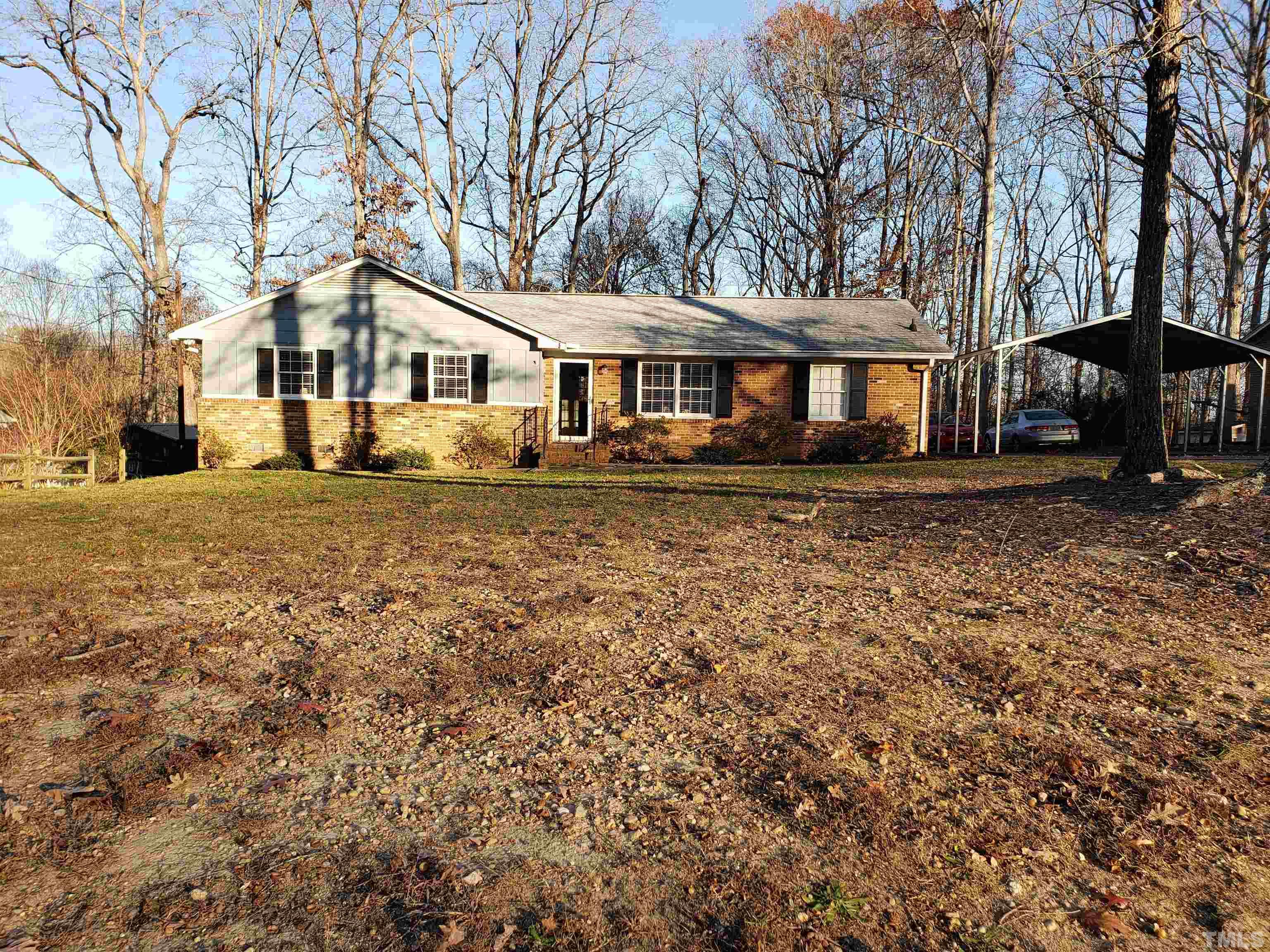 5610 Earl Road Durham, NC 27712 - Photo 4 of 38 a front view of a house with a garden