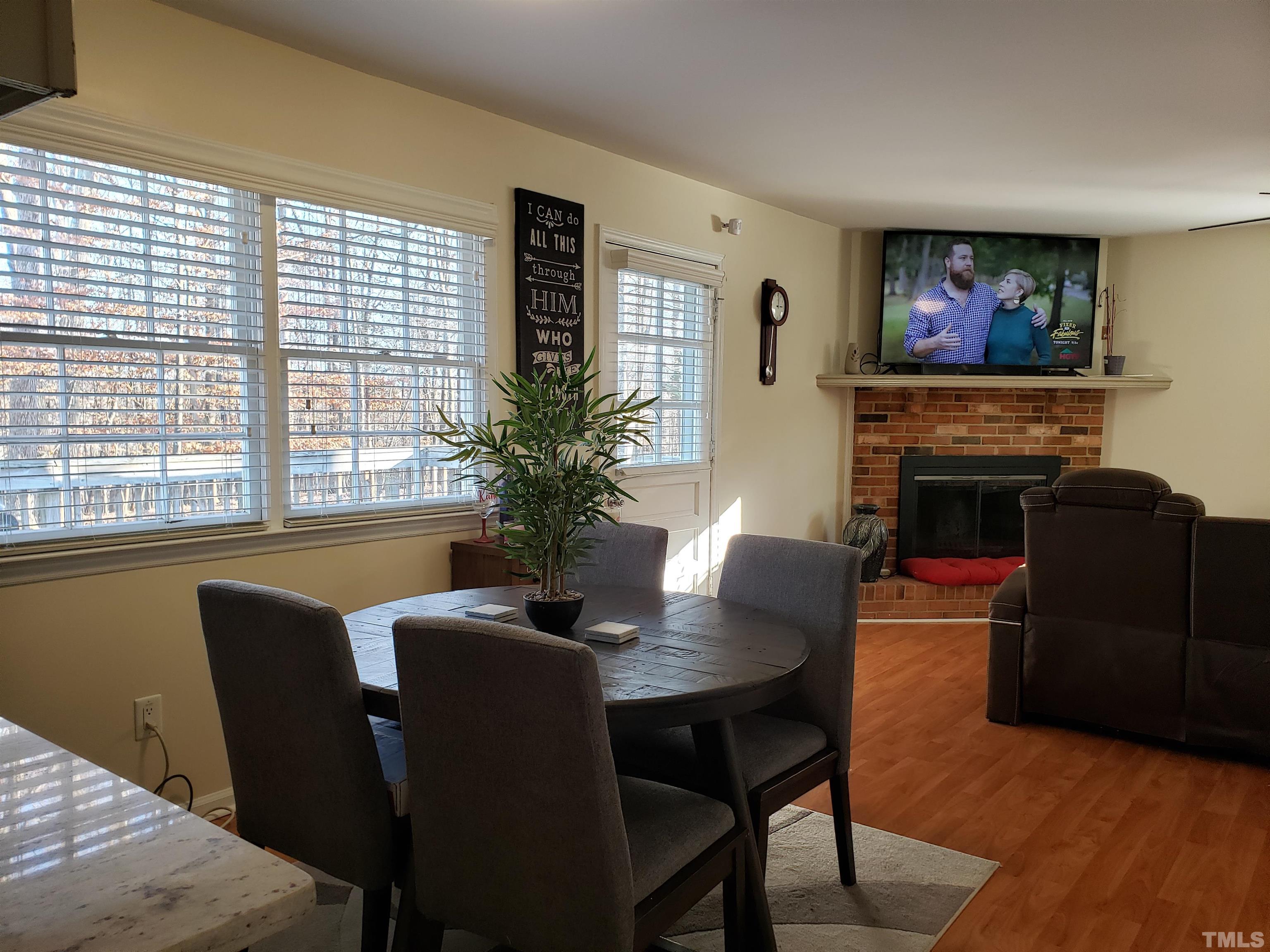 5610 Earl Road Durham, NC 27712 - Photo 32 of 38 a dining room with furniture potted plants and wooden floor