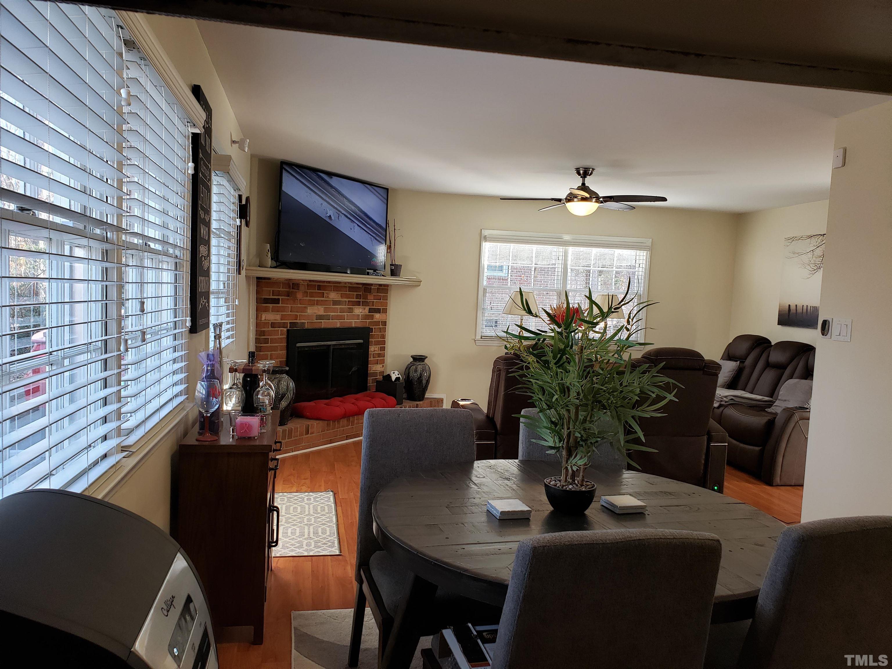 5610 Earl Road Durham, NC 27712 - Photo 33 of 38 a living room with furniture a flat screen tv and a fireplace