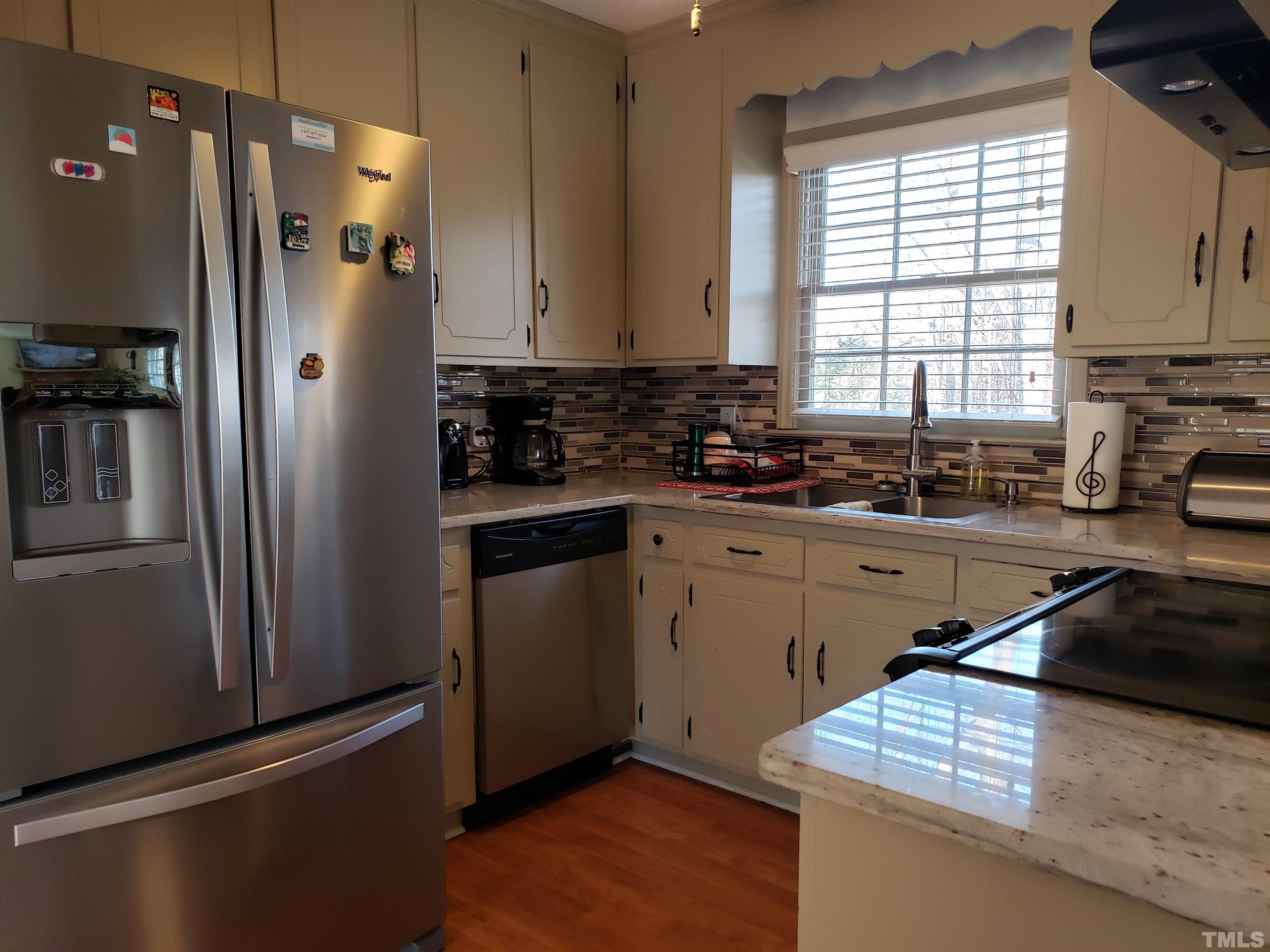 5610 Earl Road Durham, NC 27712 - Photo 35 of 38 a kitchen with a refrigerator and a sink