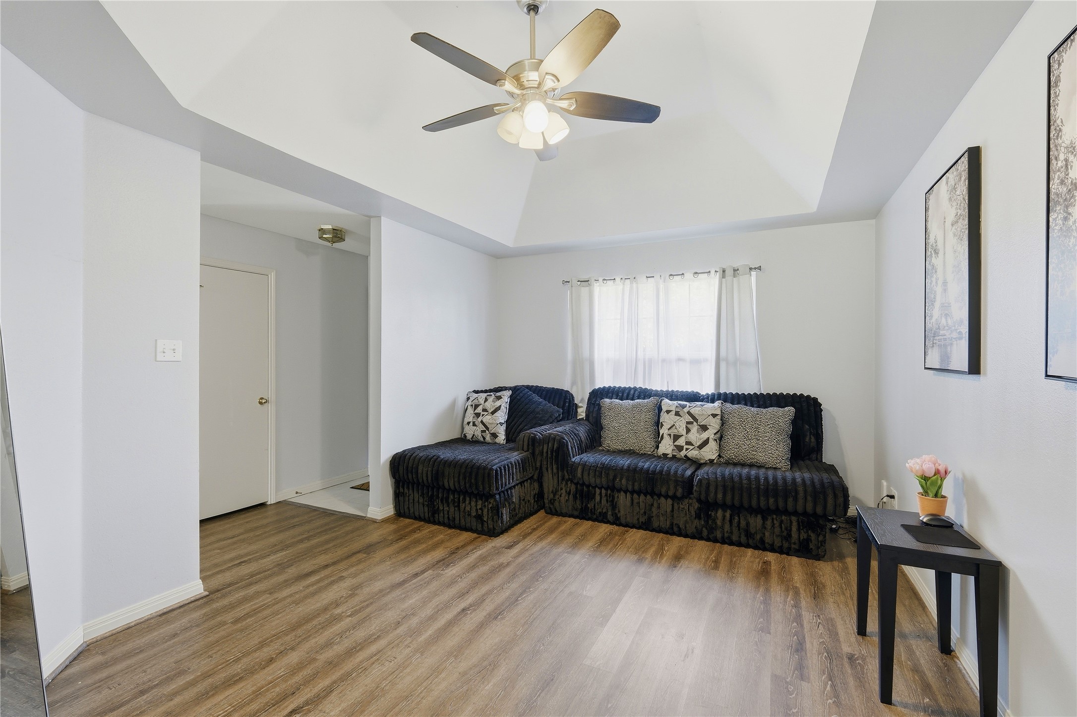 310 Raintree Drive Georgetown, TX 78626 - Photo 2 of 12 A well-lit living area features warm wood flooring and a soaring vaulted ceiling.