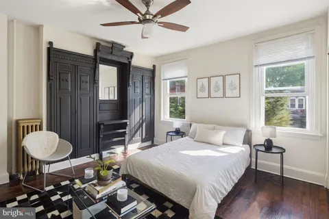 a bedroom with a bed a table and chair