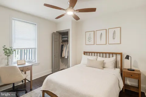 a bedroom with a bed a table and chair