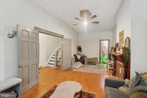 a living room with furniture and a wooden floor