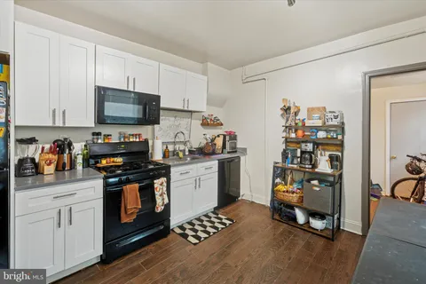a kitchen with stainless steel appliances a stove a sink and a refrigerator